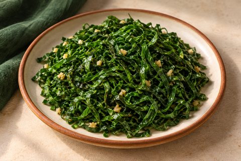 Thin green collard ribbons sautéed with small minced-garlic pieces
